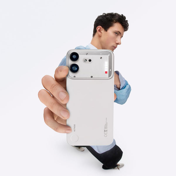 Person holding the Nothing Phone (4b) 5G in White, showing its front display, dual rear cameras and soft-touch body in a lifestyle setting
